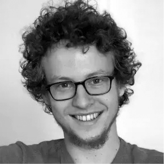 Josh Potash, A black and white image of a smiling man with curly hair and glasses.