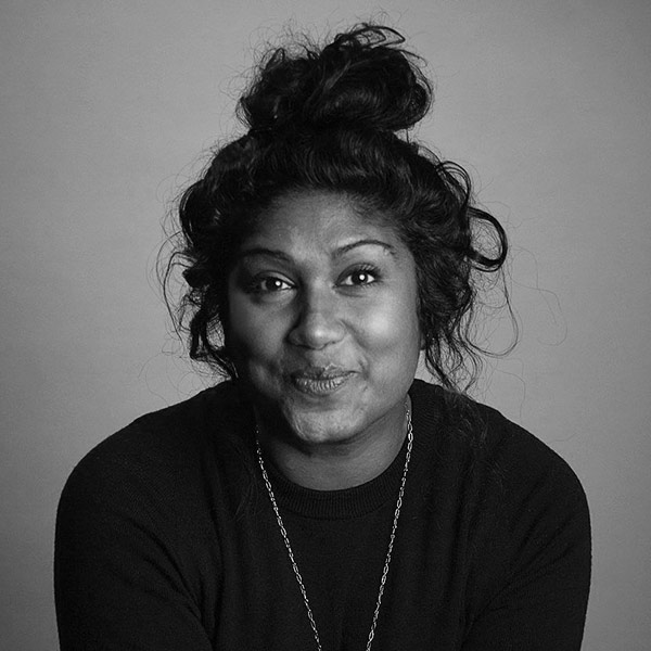 Thimali Kodikara, a dark-skinned South Asian woman with black hair up in a messy bun